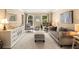 Cozy living room with neutral color palette, patterned carpet, and plenty of seating at 7575 Hunters Woods W Dr, Atlanta, GA 30350