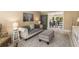Comfortable living room with neutral hues and open view into the dining area at 7575 Hunters Woods W Dr, Atlanta, GA 30350