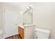 Bathroom with a vanity, mirror, and toilet, complemented by a door for privacy at 1338 Gates Se Dr, Atlanta, GA 30316