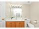 Bright bathroom features a vanity with modern lighting, a toilet, and a door for privacy at 1338 Gates Se Dr, Atlanta, GA 30316