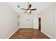Open bedroom with wood floors, a ceiling fan, and access to a closet and connected room at 1338 Gates Se Dr, Atlanta, GA 30316