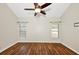 An airy bedroom with wood floors, two windows and a ceiling fan providing ample lighting at 1338 Gates Se Dr, Atlanta, GA 30316