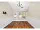 Bright dining room featuring wood floors, a modern light fixture and a glass paneled door at 1338 Gates Se Dr, Atlanta, GA 30316