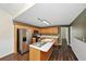 Functional kitchen featuring wood cabinetry, stainless steel appliances, central island, and modern lighting fixtures at 1338 Gates Se Dr, Atlanta, GA 30316