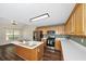 Well-equipped kitchen with stainless steel appliances, bright countertops, wooden cabinets, and a center island at 1338 Gates Se Dr, Atlanta, GA 30316