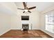 Inviting living room featuring hardwood floors, a cozy fireplace, ceiling fan, and bright natural light at 1338 Gates Se Dr, Atlanta, GA 30316
