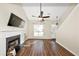 Spacious living room featuring fireplace, hardwood floors, high ceiling with fan, and large windows at 1338 Gates Se Dr, Atlanta, GA 30316