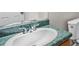 Bathroom features an oval sink, green speckled counter top, and white toilet at 35 Ravenwood Dr, Rockmart, GA 30153