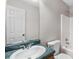 Standard bathroom features a green countertop, a single sink, and a shower-tub combo with white tile at 35 Ravenwood Dr, Rockmart, GA 30153