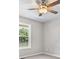 This bedroom features neutral paint, a ceiling fan, and a window with a view of the outdoors at 35 Ravenwood Dr, Rockmart, GA 30153