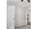 Bedroom view showcasing neutral walls, carpet, ceiling fan, and two open doorways at 35 Ravenwood Dr, Rockmart, GA 30153
