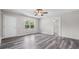 Bedroom boasting stylish gray wood flooring, neutral walls, ceiling fan, and natural light at 35 Ravenwood Dr, Rockmart, GA 30153