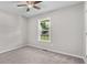 Cozy bedroom featuring a ceiling fan, carpet and a window providing natural light at 35 Ravenwood Dr, Rockmart, GA 30153
