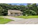 Home exterior with neutral siding, gray trim, front lawn, and a long driveway at 35 Ravenwood Dr, Rockmart, GA 30153
