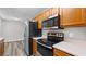 This kitchen features stainless steel appliances, oak cabinets, and white countertops at 35 Ravenwood Dr, Rockmart, GA 30153