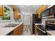 Kitchen featuring stainless steel appliances, wooden cabinets, double sinks, and vinyl floors at 35 Ravenwood Dr, Rockmart, GA 30153