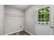 This functional laundry room includes a metal shelf and convenient exterior access at 35 Ravenwood Dr, Rockmart, GA 30153