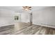 Open-concept living room features wood laminate flooring and a ceiling fan at 35 Ravenwood Dr, Rockmart, GA 30153