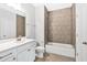 Bathroom featuring tiled shower and tub, white vanity, and tile flooring at 7449 Waterview Cv, Douglasville, GA 30135