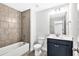 Bathroom with vanity, tile shower, and white toilet at 7449 Waterview Cv, Douglasville, GA 30135