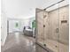 Luxurious bathroom with tile floors, soaking tub, and glass-enclosed shower with marble-patterned tile at 7449 Waterview Cv, Douglasville, GA 30135
