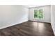 Bright bedroom with a large window, hardwood floors, and neutral wall color at 7449 Waterview Cv, Douglasville, GA 30135