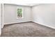 Bedroom with neutral paint, carpet, white trim, and a window at 7449 Waterview Cv, Douglasville, GA 30135
