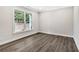 A bedroom with a large window providing natural light and a view of the outdoors at 7449 Waterview Cv, Douglasville, GA 30135