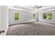 Spacious bedroom with trey ceiling, fan, and multiple windows for natural light at 7449 Waterview Cv, Douglasville, GA 30135