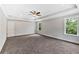 Spacious bedroom featuring tray ceiling with ceiling fan and bright windows at 7449 Waterview Cv, Douglasville, GA 30135