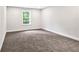 Bright bedroom with carpet, white trim, neutral paint, and a window at 7449 Waterview Cv, Douglasville, GA 30135