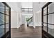 Elegant foyer showcasing soaring ceilings, hardwood floors, and a staircase with iron railing at 7449 Waterview Cv, Douglasville, GA 30135