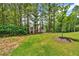 Scenic front yard with a lush lawn and landscaping leading to a stately two-story home at 7449 Waterview Cv, Douglasville, GA 30135