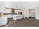 Modern kitchen with white cabinets, stainless steel appliances, an island, and hardwood floors at 7449 Waterview Cv, Douglasville, GA 30135