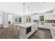 Gourmet kitchen featuring a large island, stainless appliances, and access to the living room and outdoor deck at 7449 Waterview Cv, Douglasville, GA 30135