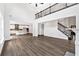 Spacious living room with high ceilings, hardwood floors, and an open floor plan to the kitchen and staircase at 7449 Waterview Cv, Douglasville, GA 30135