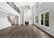 Open living room boasting high ceilings, hardwood floors, a fireplace, large windows, and a staircase at 7449 Waterview Cv, Douglasville, GA 30135