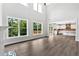 Bright open floor plan with large windows, hardwood floors, connecting the living room to the kitchen at 7449 Waterview Cv, Douglasville, GA 30135
