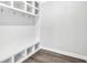 Mudroom with built-in storage cubbies, bench, hooks, and gray wood-look flooring at 7449 Waterview Cv, Douglasville, GA 30135