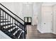 Grand staircase with dark wood railing and steps, leading to the upper level of the home at 7449 Waterview Cv, Douglasville, GA 30135