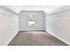 Spacious walk-in closet with carpet, wire racks, window, and neutral paint at 7449 Waterview Cv, Douglasville, GA 30135