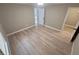 Spacious bedroom with wood-look floors and neutral walls, featuring a doorway and hallway access at 1090 Coleman Sw St, Atlanta, GA 30310