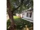 A quaint single-story house with red shutters and a small wooden porch, nestled on a grassy lot with mature trees at 1090 Coleman Sw St, Atlanta, GA 30310