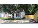 Charming single-story home with a well-manicured lawn and red shutters, shaded by a mature tree and a fenced-in backyard at 1090 Coleman Sw St, Atlanta, GA 30310