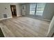 Open-concept living room with modern flooring and ample natural light, showcasing a seamless blend of comfort and style at 1090 Coleman Sw St, Atlanta, GA 30310