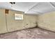 Unfinished basement featuring painted floors, a small window, and dated decor at 2991 Monterey Drive Dr, Decatur, GA 30032