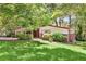 Attractive single-story home with a carport, brick accents, and lush landscaping at 2991 Monterey Drive Dr, Decatur, GA 30032
