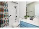 Full bathroom featuring a tub, shower, patterned shower curtain, and blue vanity at 4776 Harrod Ct, Douglasville, GA 30135