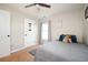 Neutral bedroom with a ceiling fan, gaming decor, and a cozy bed with decorative pillows at 4776 Harrod Ct, Douglasville, GA 30135