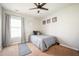 Cozy bedroom featuring a ceiling fan, comfortable bed, and natural light from a window at 4776 Harrod Ct, Douglasville, GA 30135